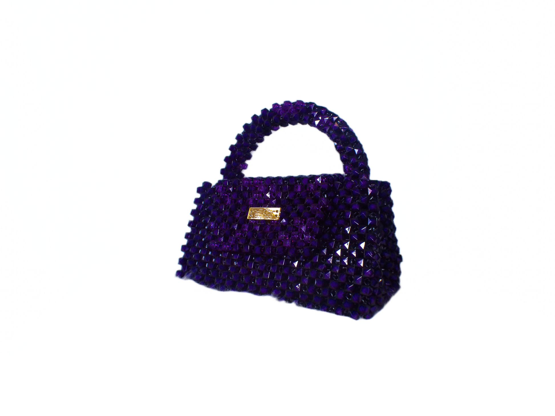 Purple beaded handbag with a gold clasp on a white background